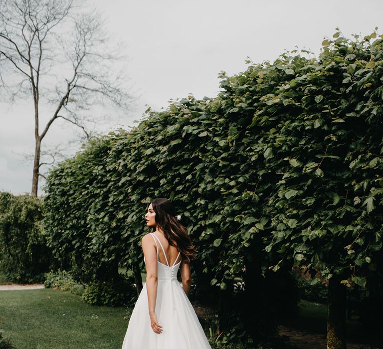 Bride in a princess wedding dress with full skirt, fitted bodice and double thin strap back detail from the new Suzanne Neville Nova 2022 bridal collection