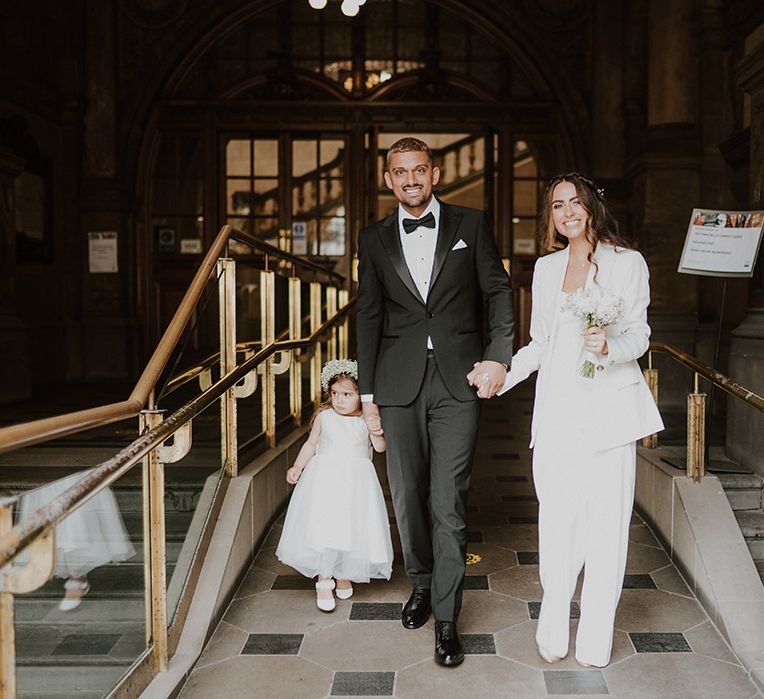 Intimate family wedding at Sheffield registry office with bride and groom in Reiss Suits with their daughter in a gypsophila flower crown 