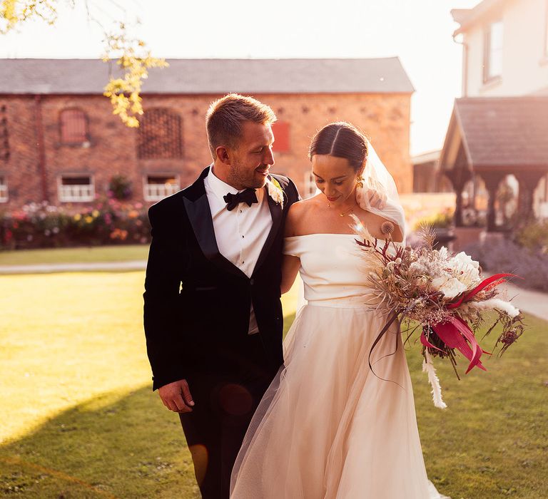 Bride in off the shoulder dress with pampas grass bouquet