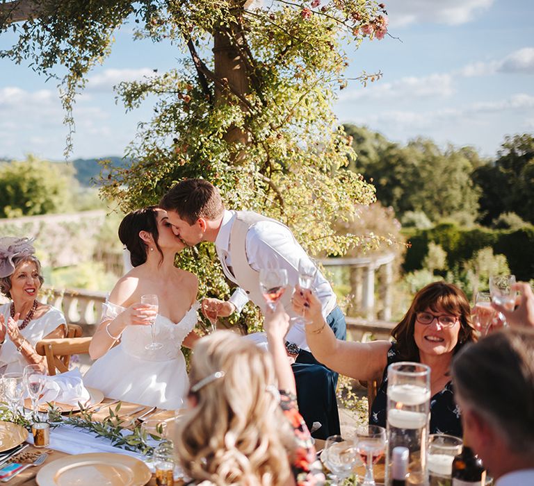 Bride & groom kiss during wedding reception