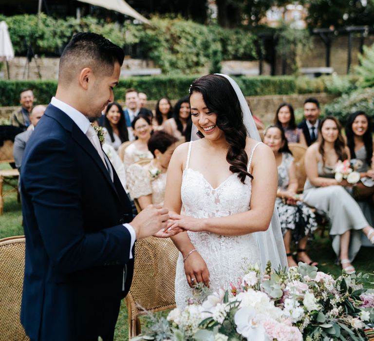 Brides dress glistens as she smiles with joy 