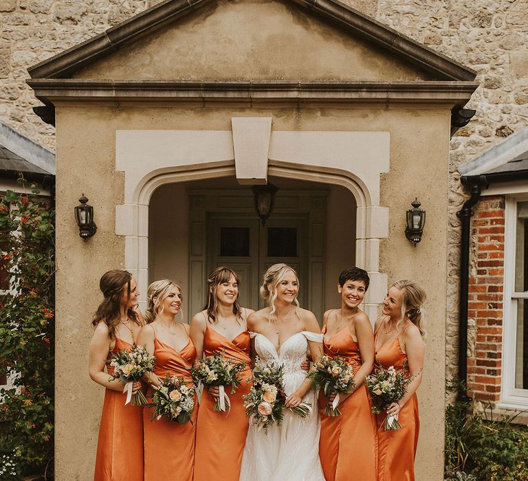 Orange bridesmaid dresses with bouquets