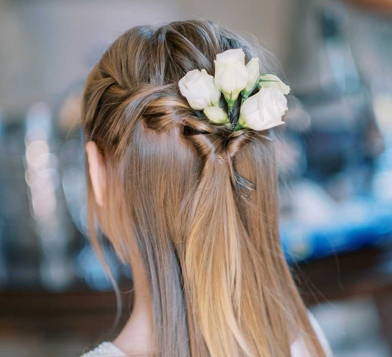 Flower girl with half up half down wedding hair and white roses 