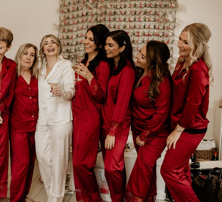 Bridal party in white and red satin pyjamas on the wedding morning 