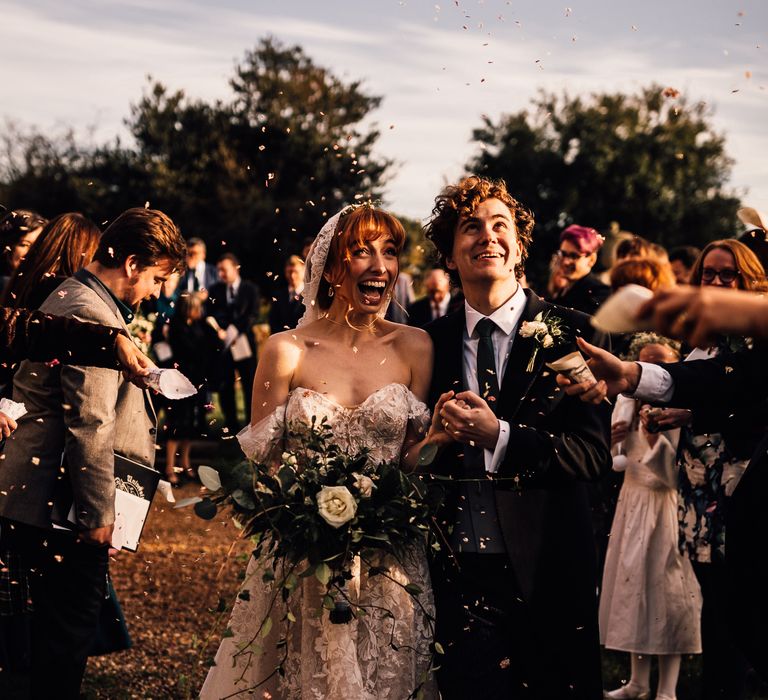 Confetti moment for bride and groom at Oxnead Hall venue in Norfolk