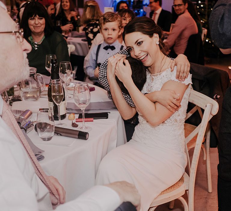 Bride hugs wedding guest on her wedding day