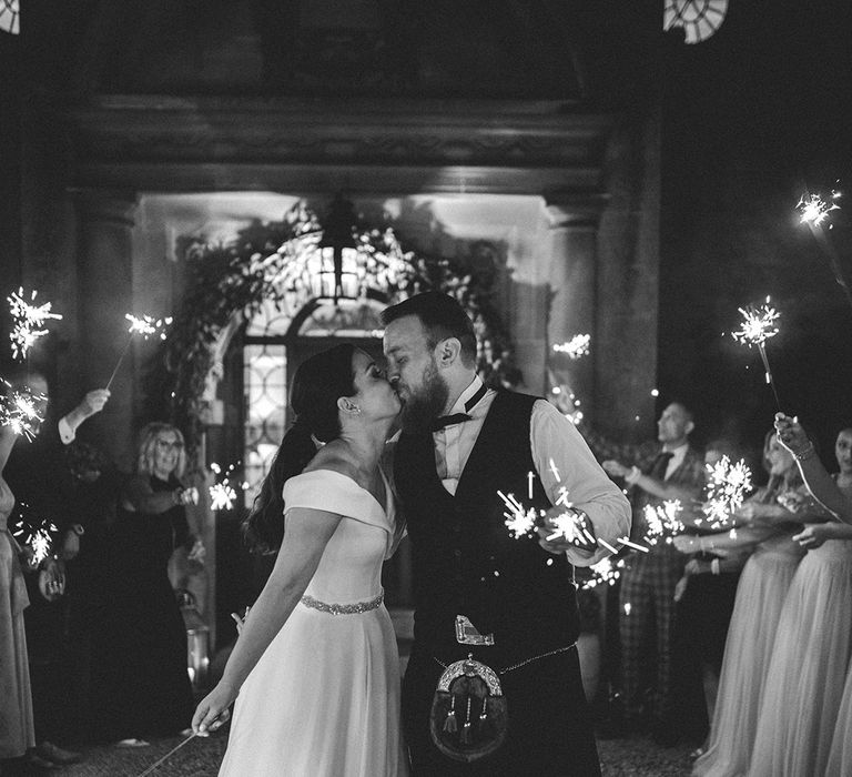 Sparkler moment at Foxhill Manor with bride in a Bardot wedding dress and groom in a tartan kilt 