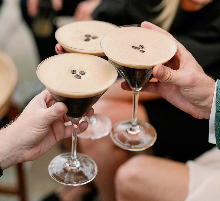 Guests make a toast with espresso martinis 