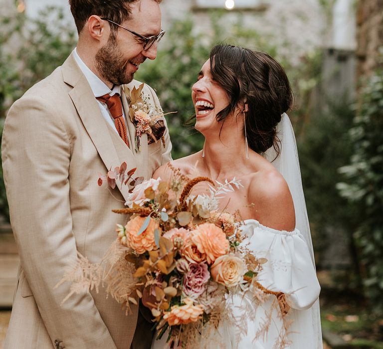 Bride and groom gaze into each other's eyes and smile after their wedding ceremony