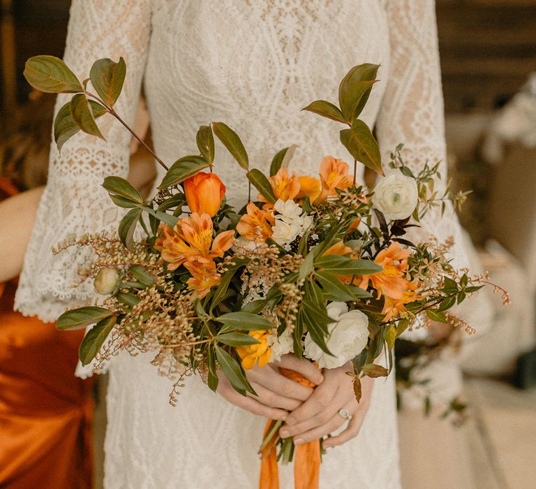 Bridal orange and white wedding bouquet with foliage 