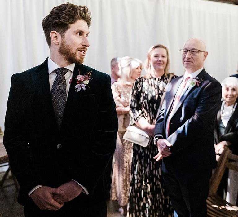 Groom turns to look at the bride for wedding ceremony