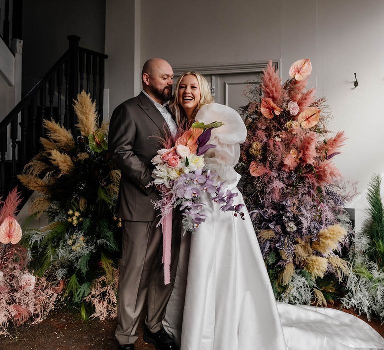 pink pampas grass, astilbe, and anthuriums column flower arrangements for modern stylish London wedding with bride in a princess wedding dress 