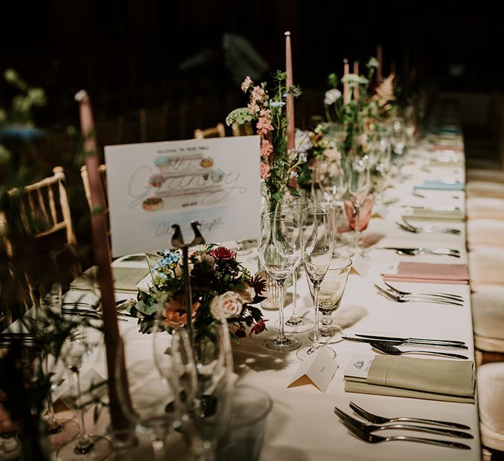 Pastel coloured tablescape complete with different coloured pastel napkins and small bouquets 