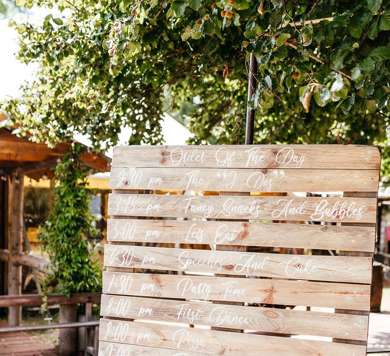 Wooden pallet order of the day wedding sign with white font 