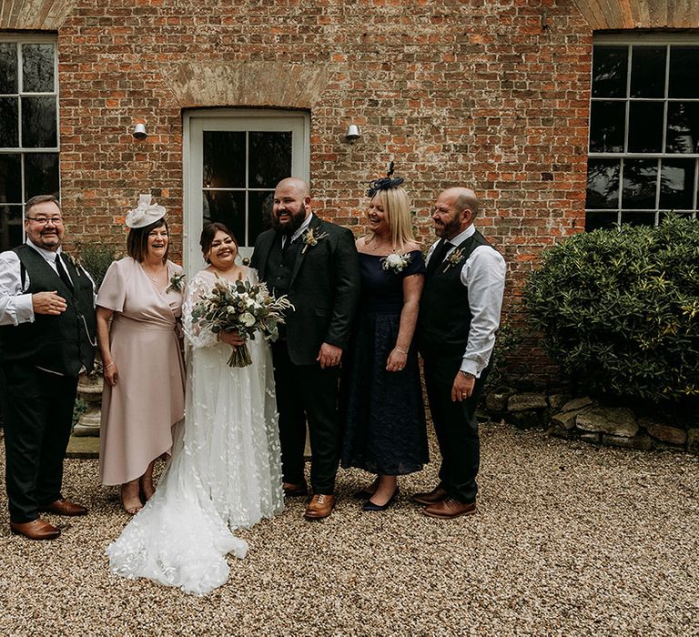 Bride and groom with their parents on their wedding day 