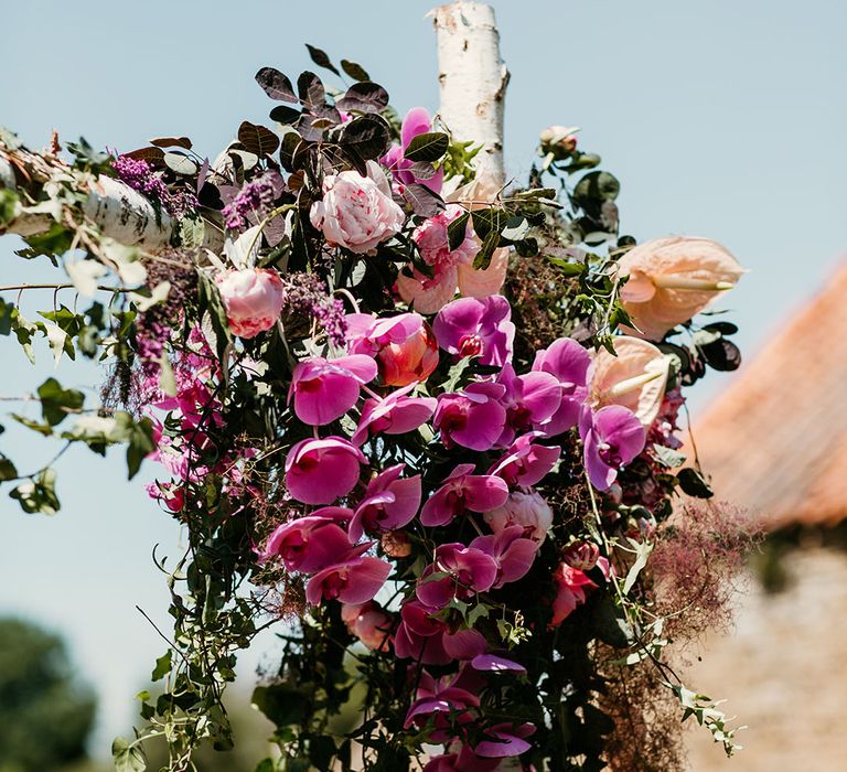 Wedding flower arrangement decorations with pink orchid wedding flowers, peonies and anthuriums 