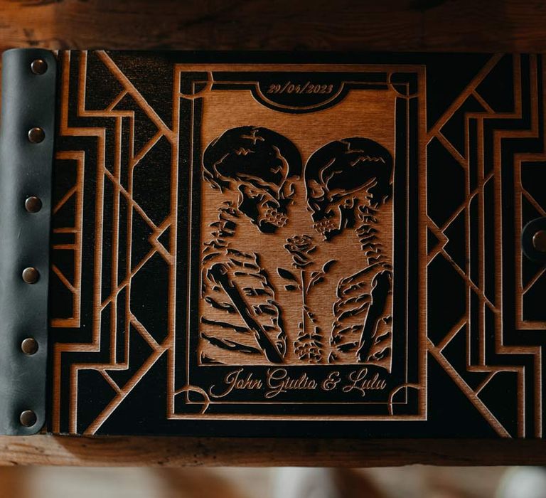 Alternative wedding guest book with skulls and a garden rose - death do us part at Southlands Barn