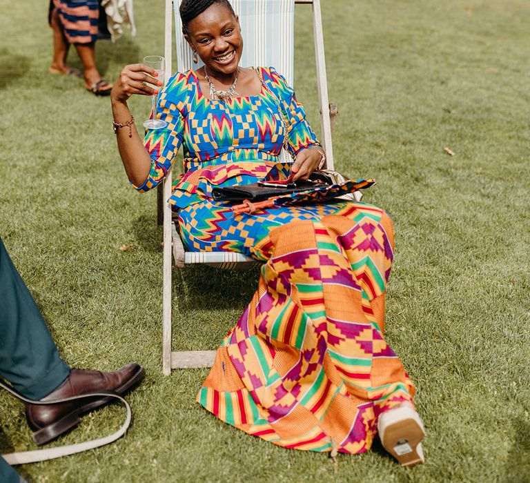 Wedding guest in colourful patterned outfit for multicultural wedding 