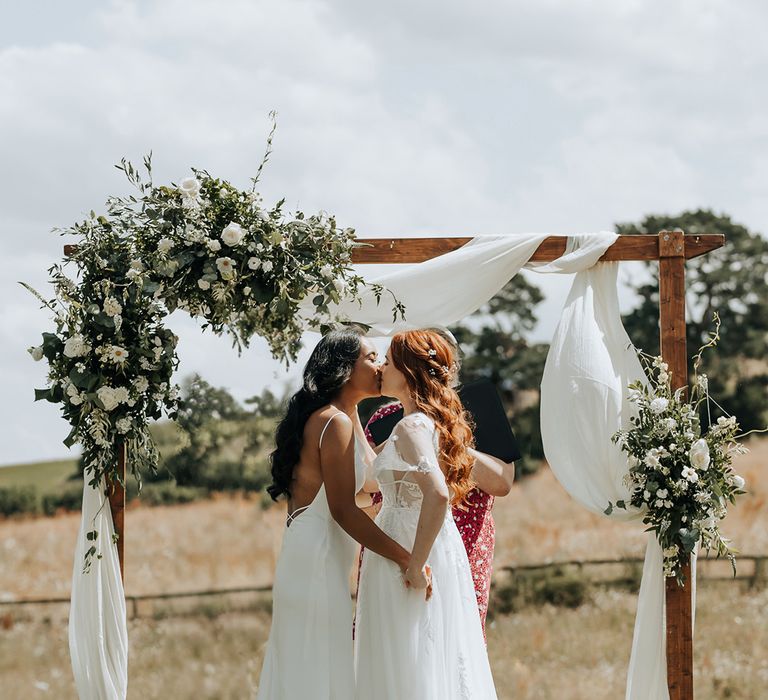 Lyde Court with wooden altar decoration covered in white drapery for whimsical wedding 