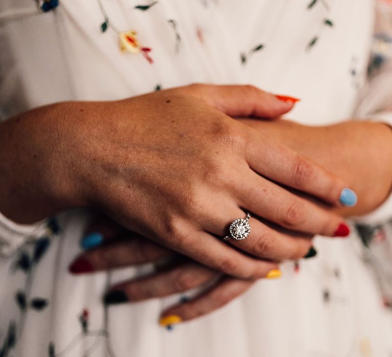 Bride with bright colourful nails with diamond engagement ring 