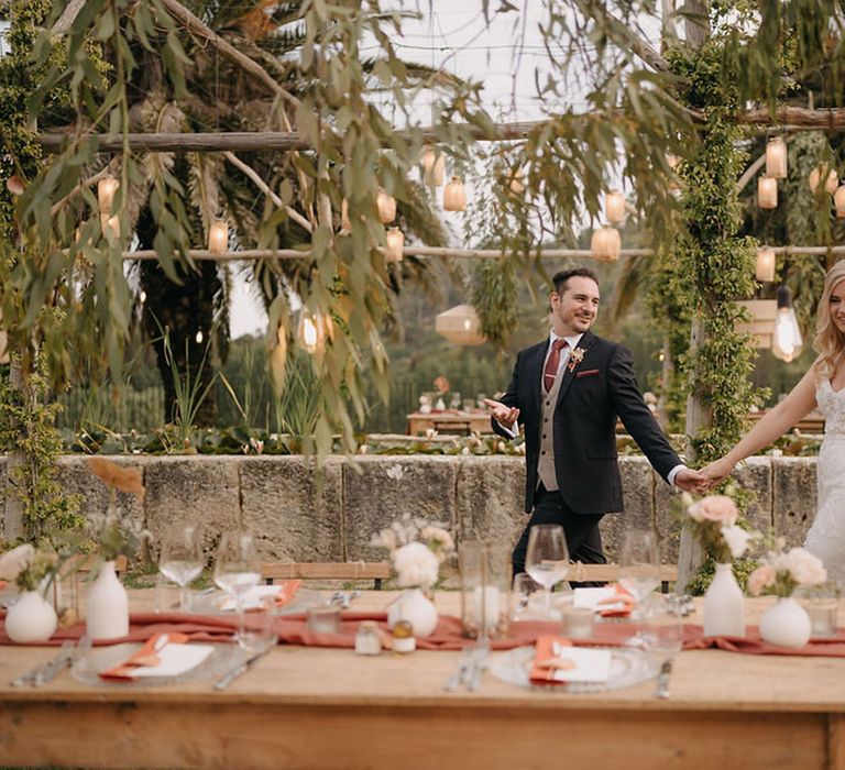 The bride and groom walk around their wedding breakfast together at Sicily wedding venue 