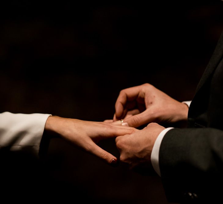 Bride and groom exchange wedding rings