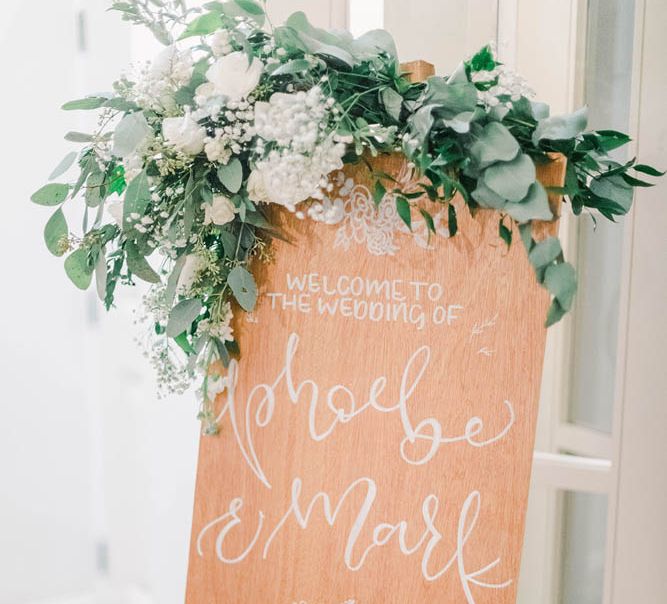 Wooden wedding welcome sign at black tie winter wedding