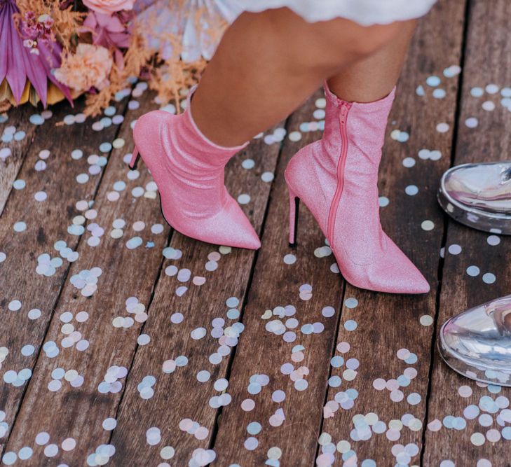 Pink bridal boots and shiny silver trainers 