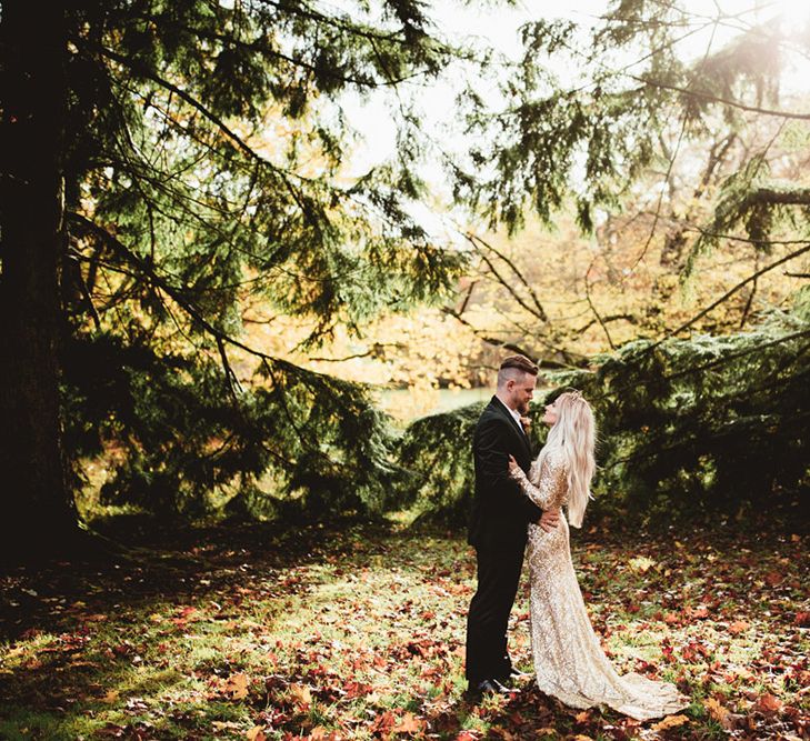 Bride and groom in woodland shoot. Bride wears a gold sequin dress. Photography by Maryanne Weddings.