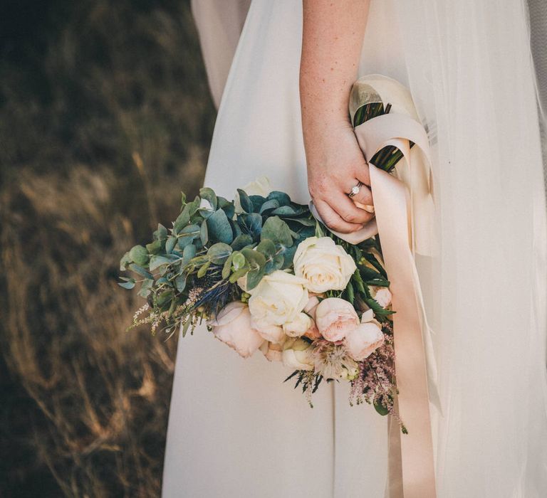 Bridal bouquet including roses, thistles and eucaluptus