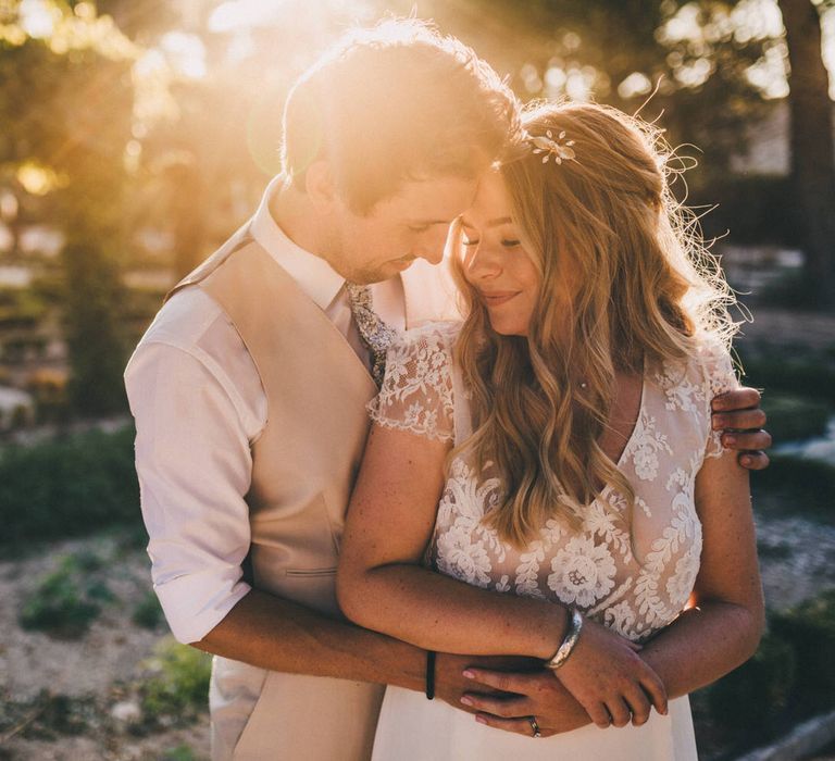 Bride and groom embrace in the fields at Le Mas De La Rose