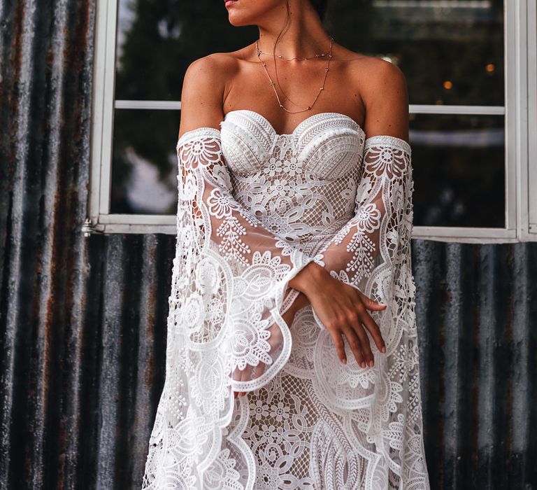 Bride wears lace gown with sweetheart neckline and detachable sleeves