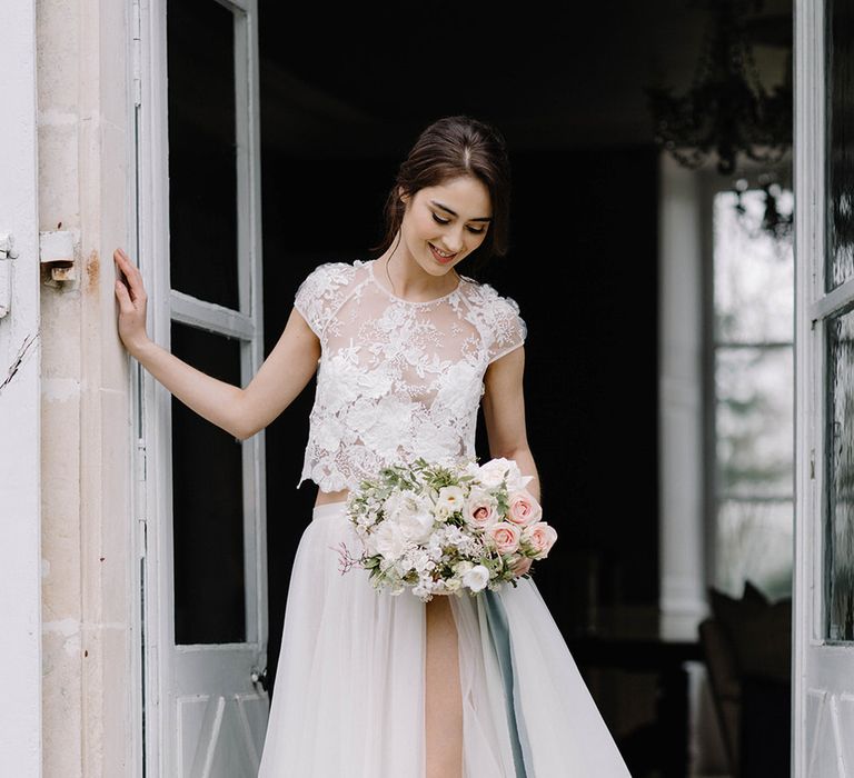 The bride wore a two piece wedding outfit with a slit tulle skirt for a chic French look