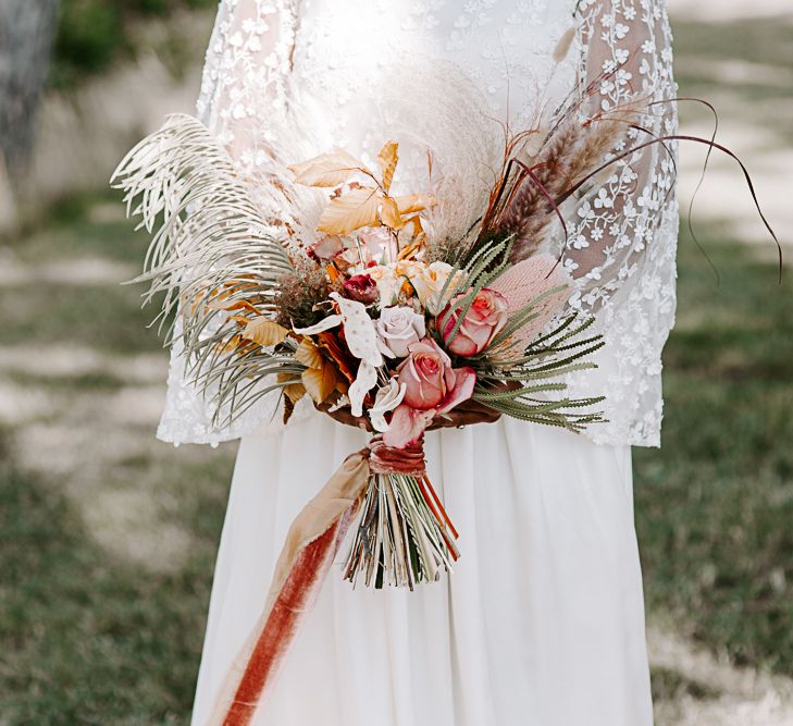 Dried floral arrangement tied with ribbon