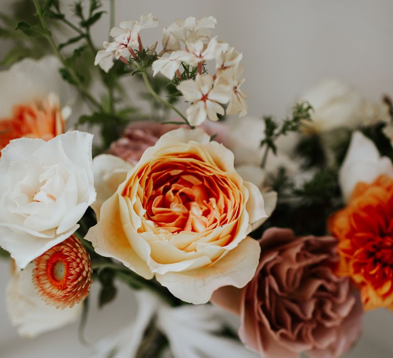 Pastel orange, white and gold wedding flower bouquet