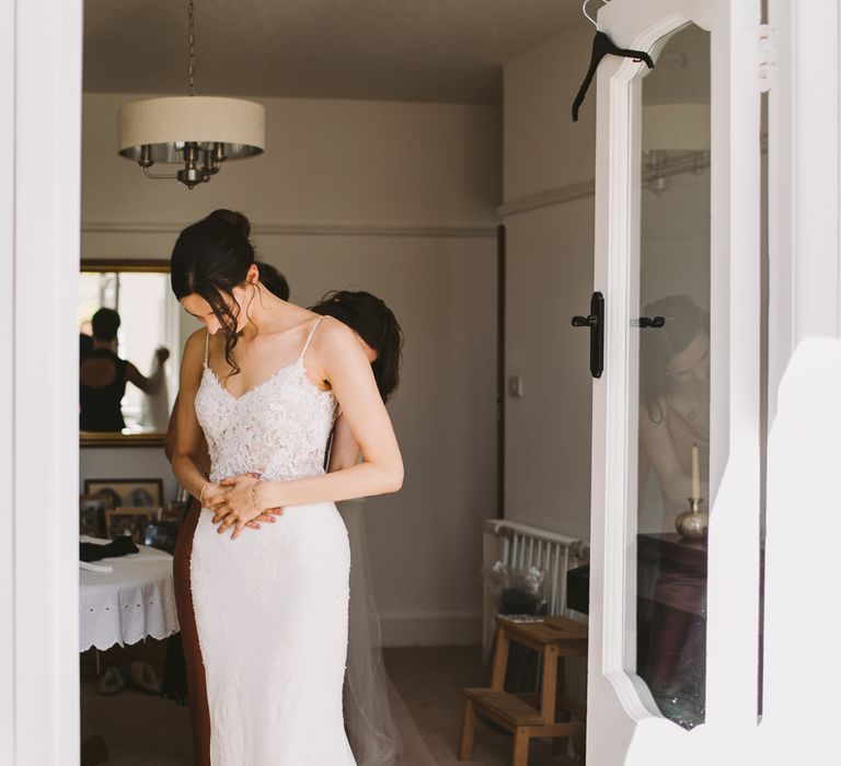 Dark haired bride getting ready on the morning of her wedding day