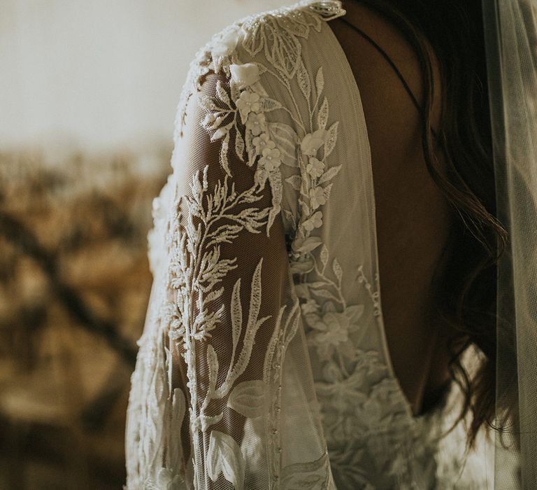 Lace embroidery and embellishment on the shoulder detail of a Julita London gown 