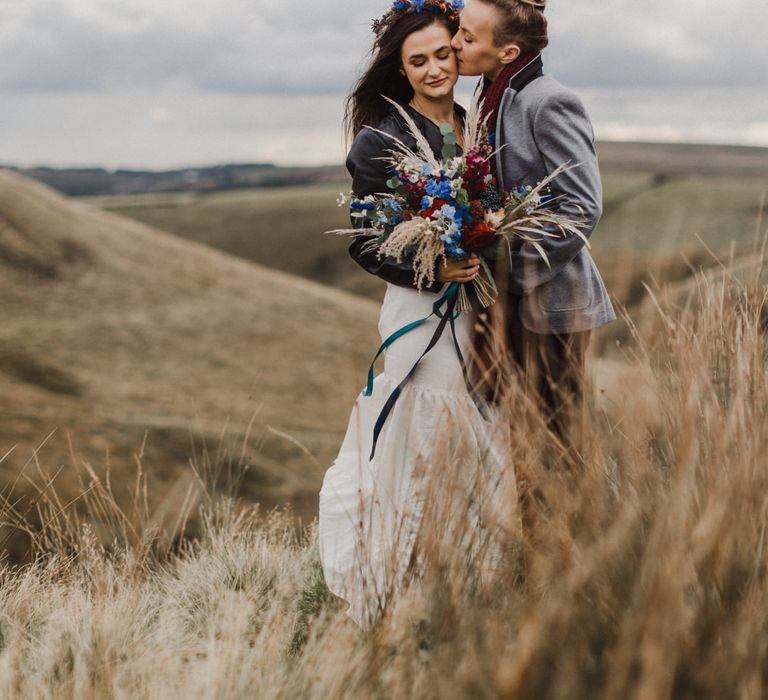 A laid back Peak District elopement for two brides with a bright bouquet and red scarf