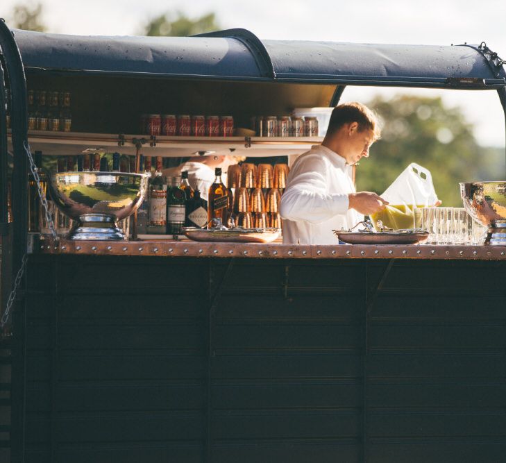 Horse cart mobile bar with bartender topping up cocktails - Image courtesy of Marble Private