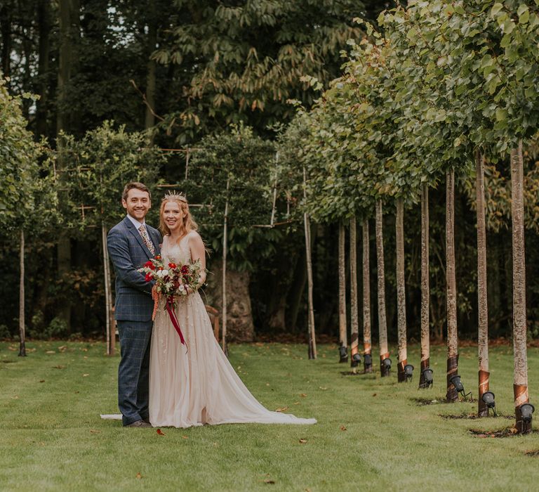 Bride and groom portrait in the gardens at Hazel Gap Barn with bride in a blush tulle and pearl wedding dress