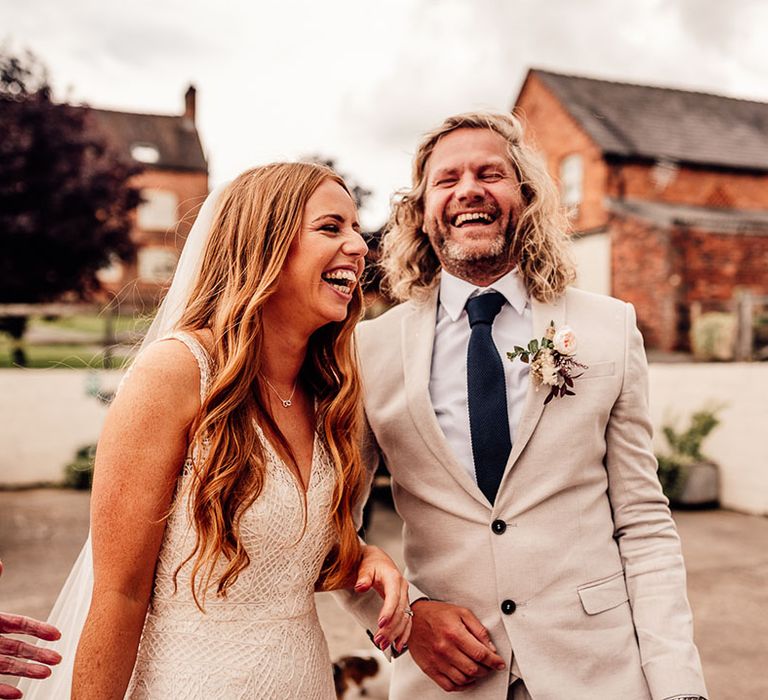 Groom in cream wedding suit 