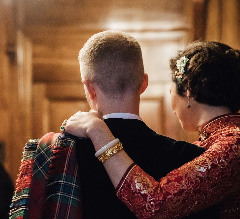 Bride wears gold jewellery with red cheongsam dress