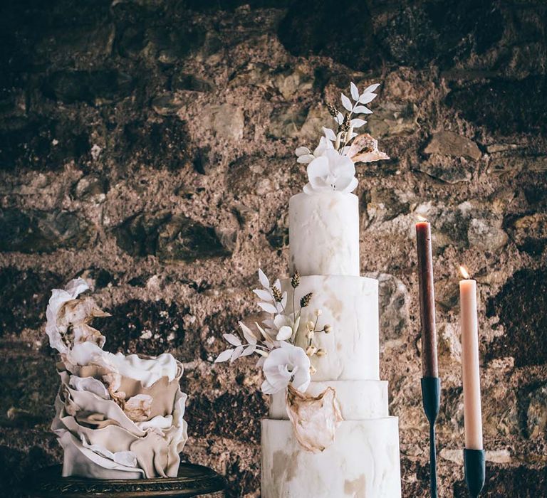 Wedding cake table with three rustic wedding cakes with ruffle and marble designs