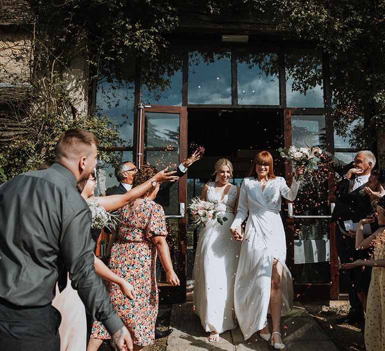 Confetti exit for brides at The Great Tythe Barn wedding