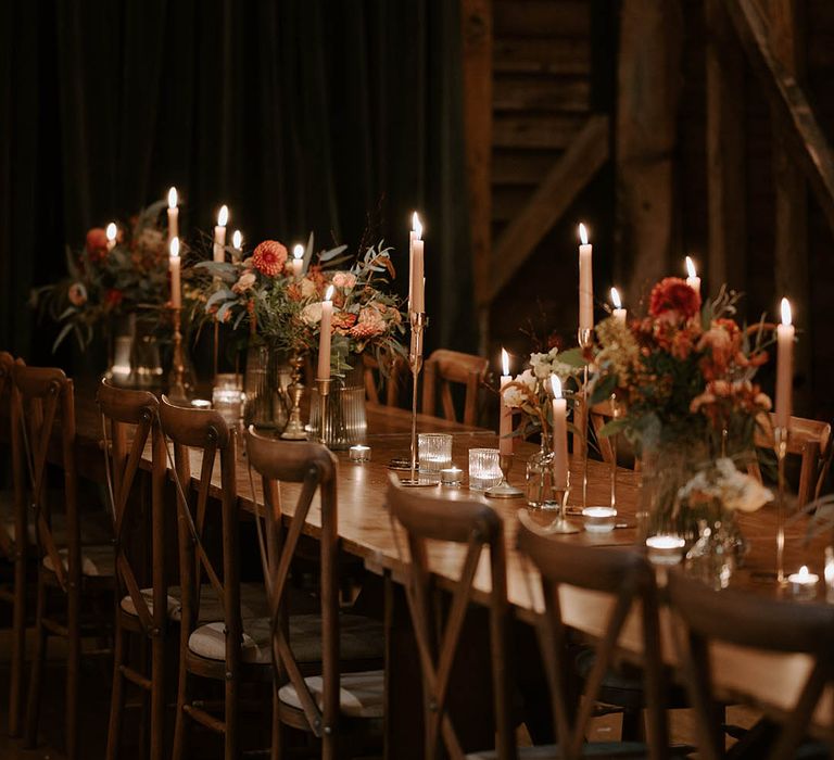 Candlelit wedding tables with flower centrepieces