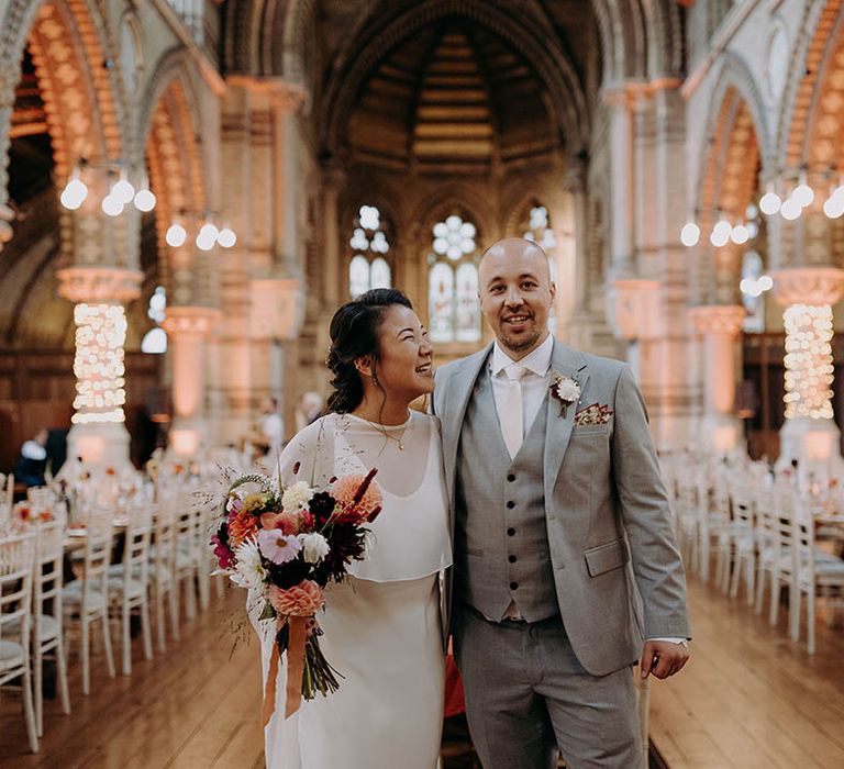 Bride looks lovingly at groom on their wedding day after ceremony