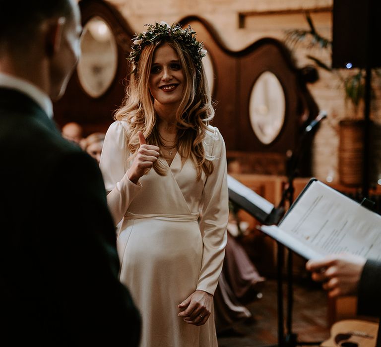 Bride wears her blonde hair in loose waves and floral crown