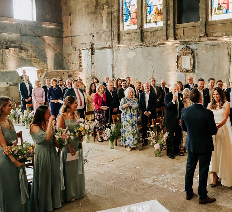 Bride and groom get married at Asylum Chapel wedding venue with stained glass windows