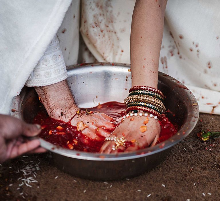 Bride and groom take part in customs for traditional Indian wedding ceremony for multicultural wedding