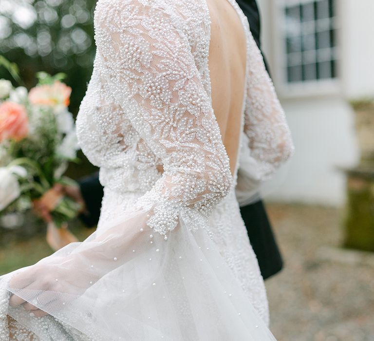 delicate beaded wedding dress with open back detail and puddle train 